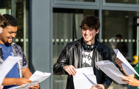Group of smiling students opening their results