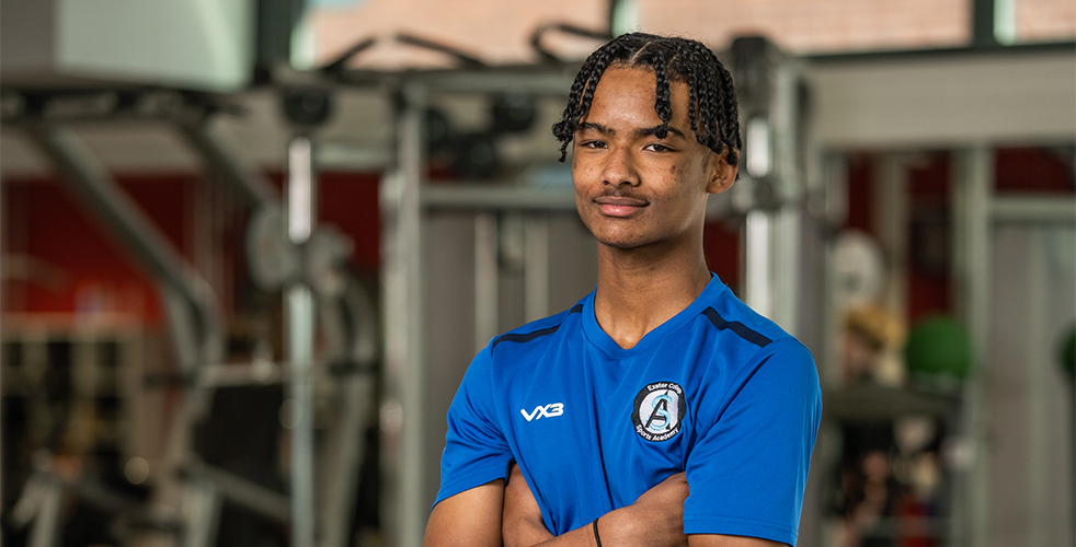 Male Student portrait smiling at the camera in the Exeter College sports academy kit
