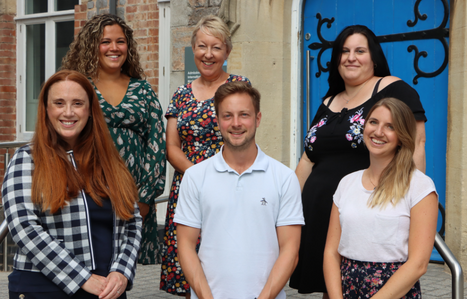 College advisors smiling at the camera in front of the St David's Buidling