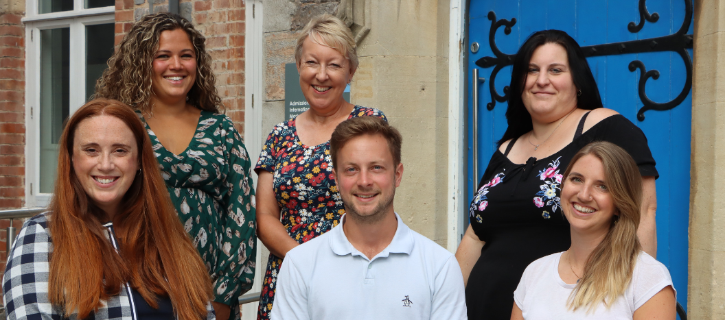 College advisors smiling at the camera in front of the St David's Buidling