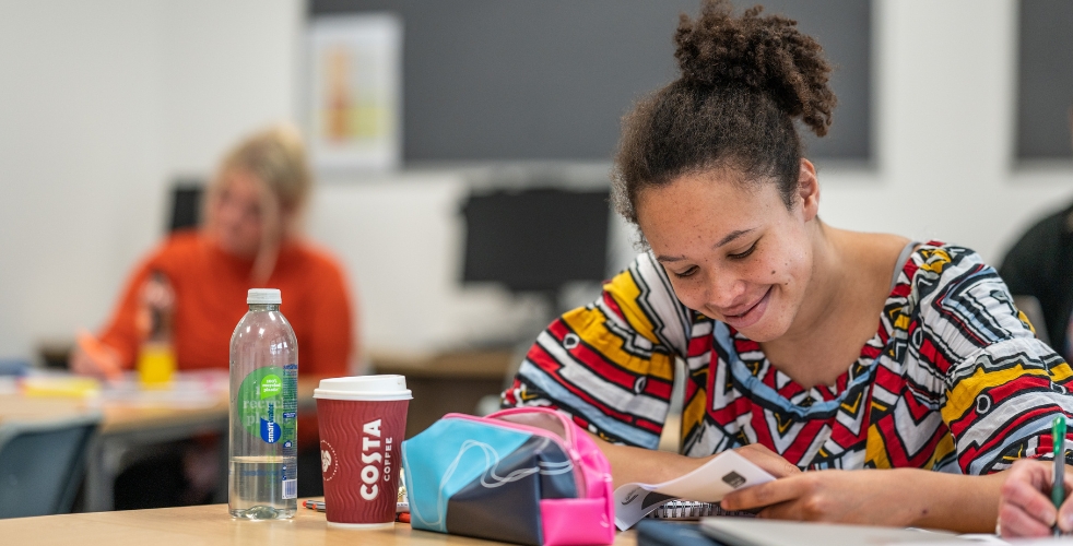 smiling student looking at her studies