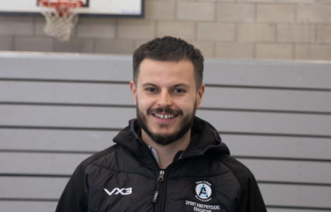 Exeter College sports staff portrait in the sports hall