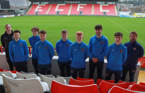 Exeter College Football students and coaches on the sports field at Exeter city