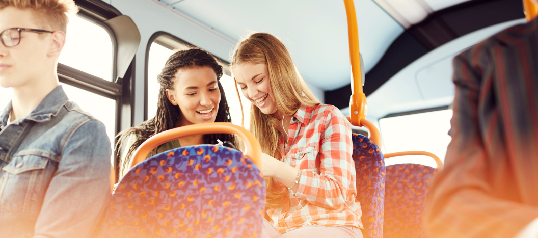 Two girls sat on a bus