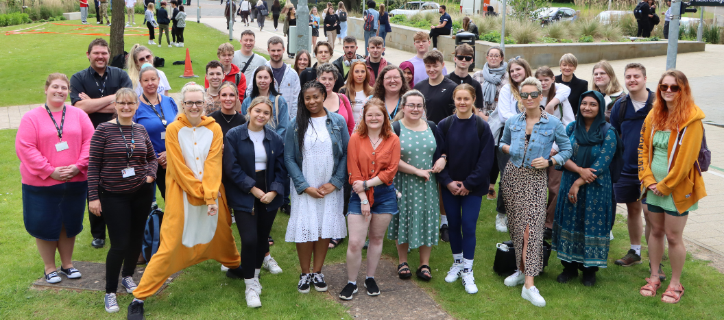 Higher Education students stood in a group outside the front of the IoT on Hele Site