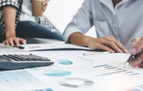 two people working on finance plans at a desk