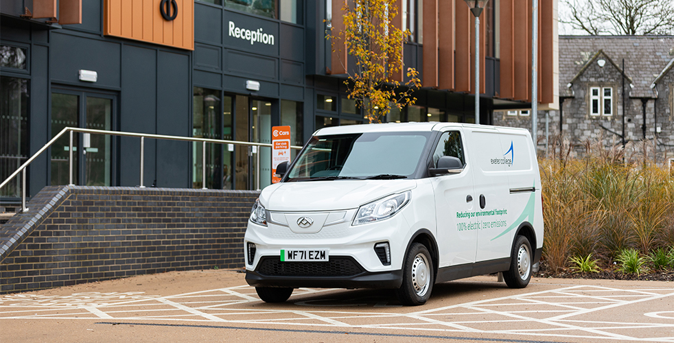 Branded Exeter College Electric van parked outside the Hele site