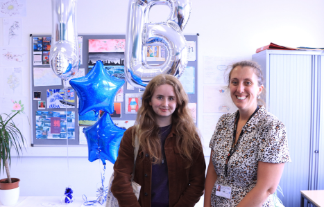 A student poses with her teacher on IB results day.