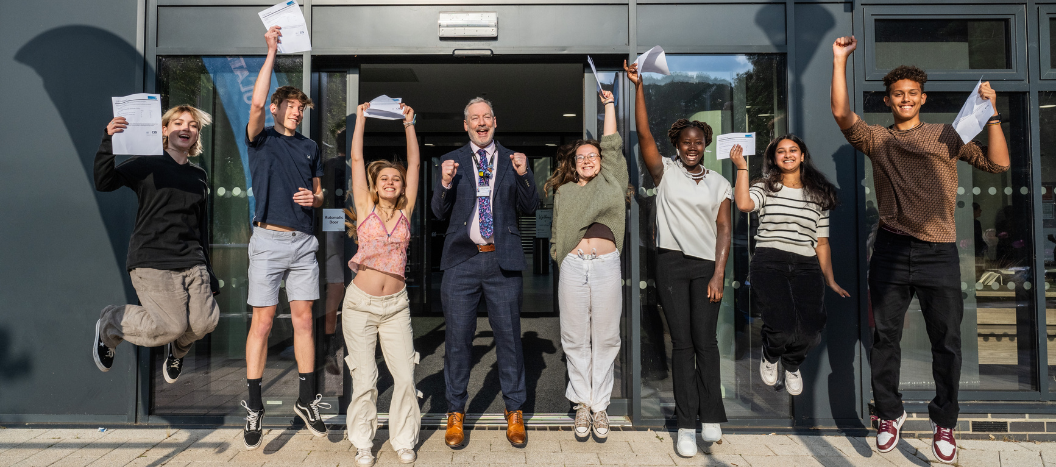 Students jump in the air to celebrate their results