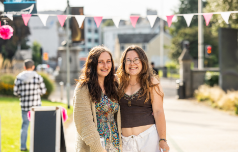 Two students smile at the camera