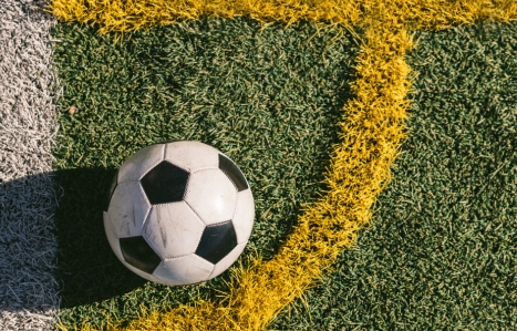 Close up of a football in the corner of a pitch