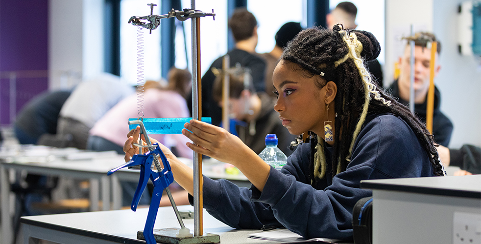 Female Engineering student measuring distance