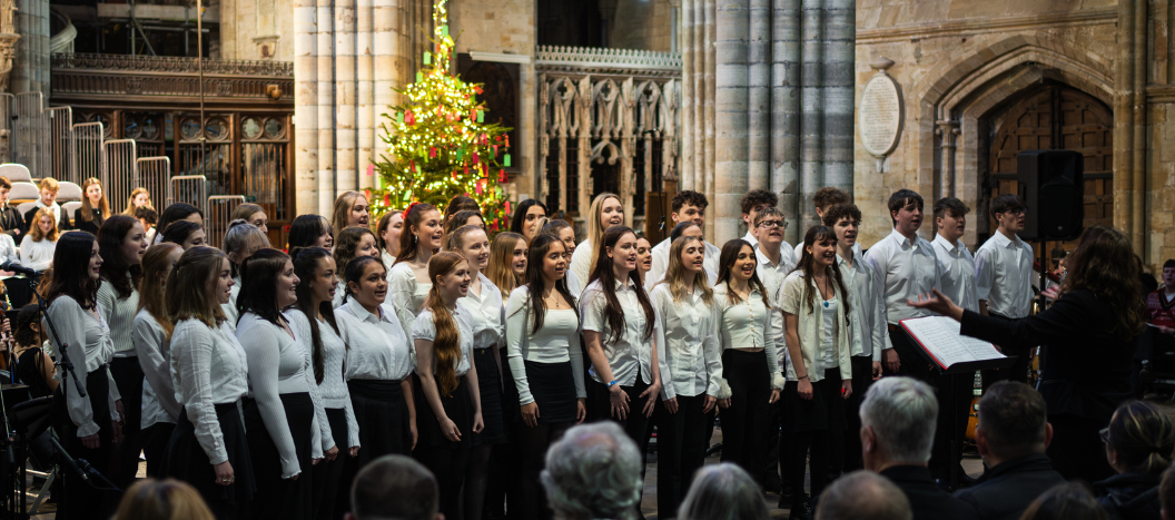 Group of students singing at the front of the cathedral