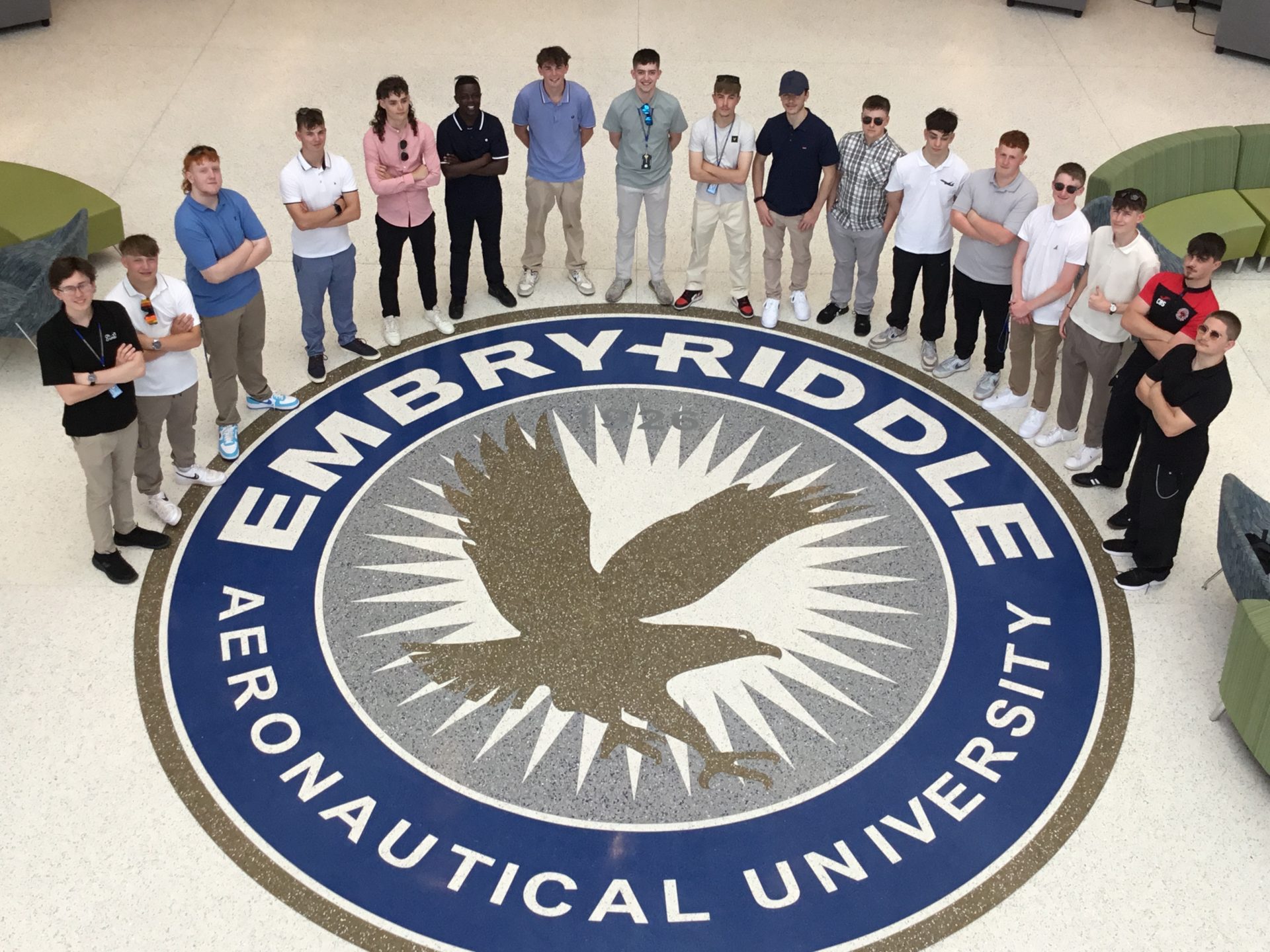 Aerospace students standing in around the Embry-Riddle aeronautical university logo