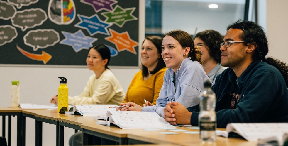 a line of learners smiling in an adult learning leisure course