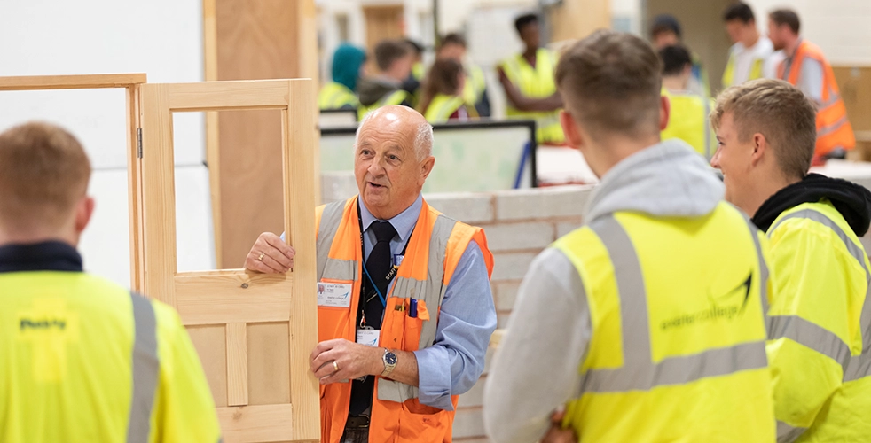 Teacher with apprenticeship students in construction