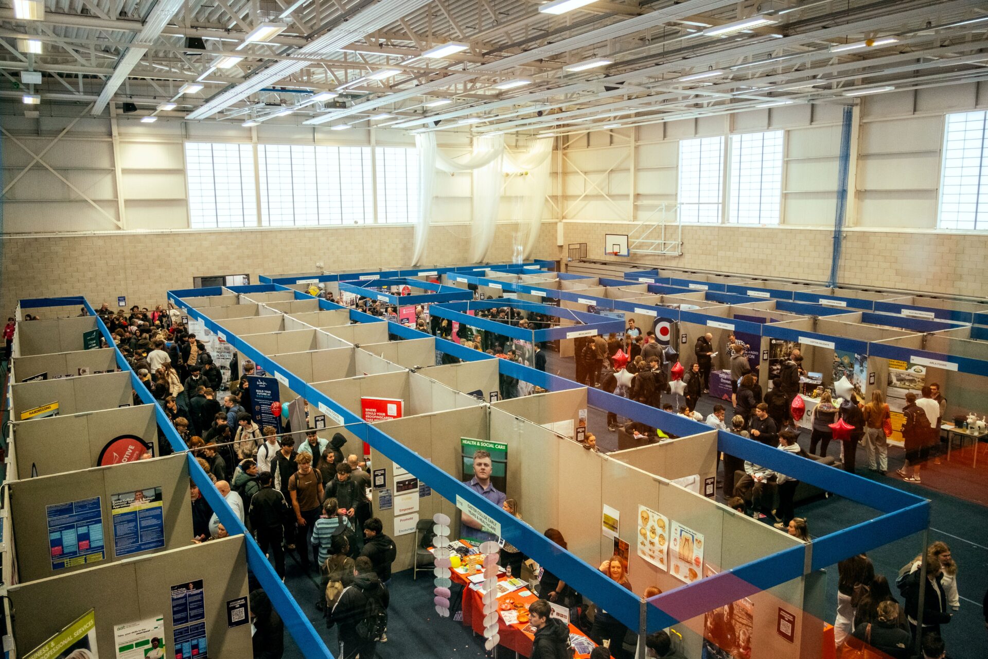 Sports hall filled with booths and students