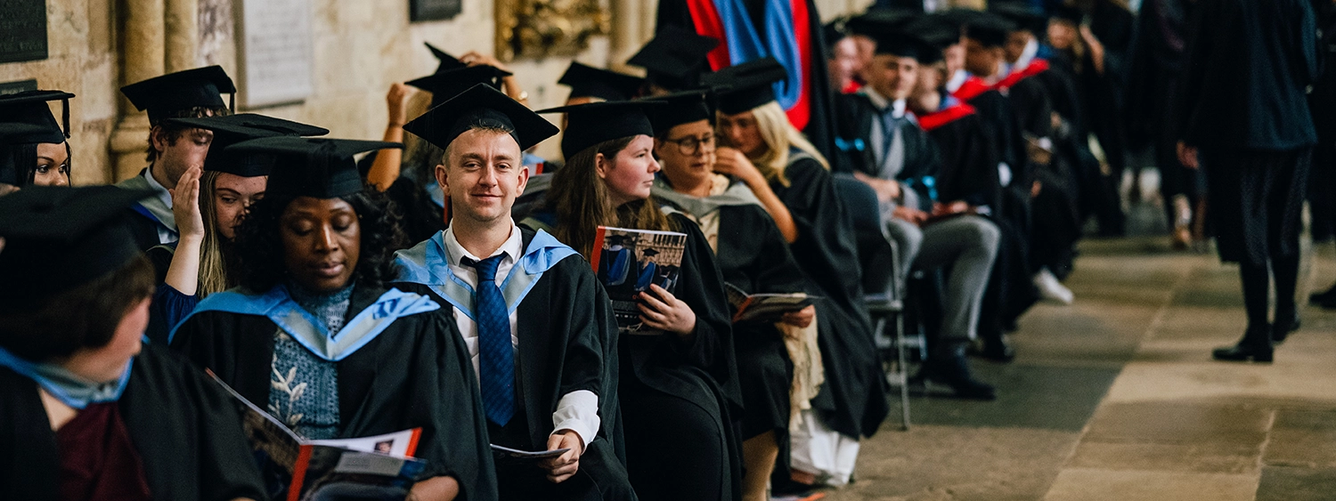 Students dressed in graduation gowns in Exeter Cathedral
