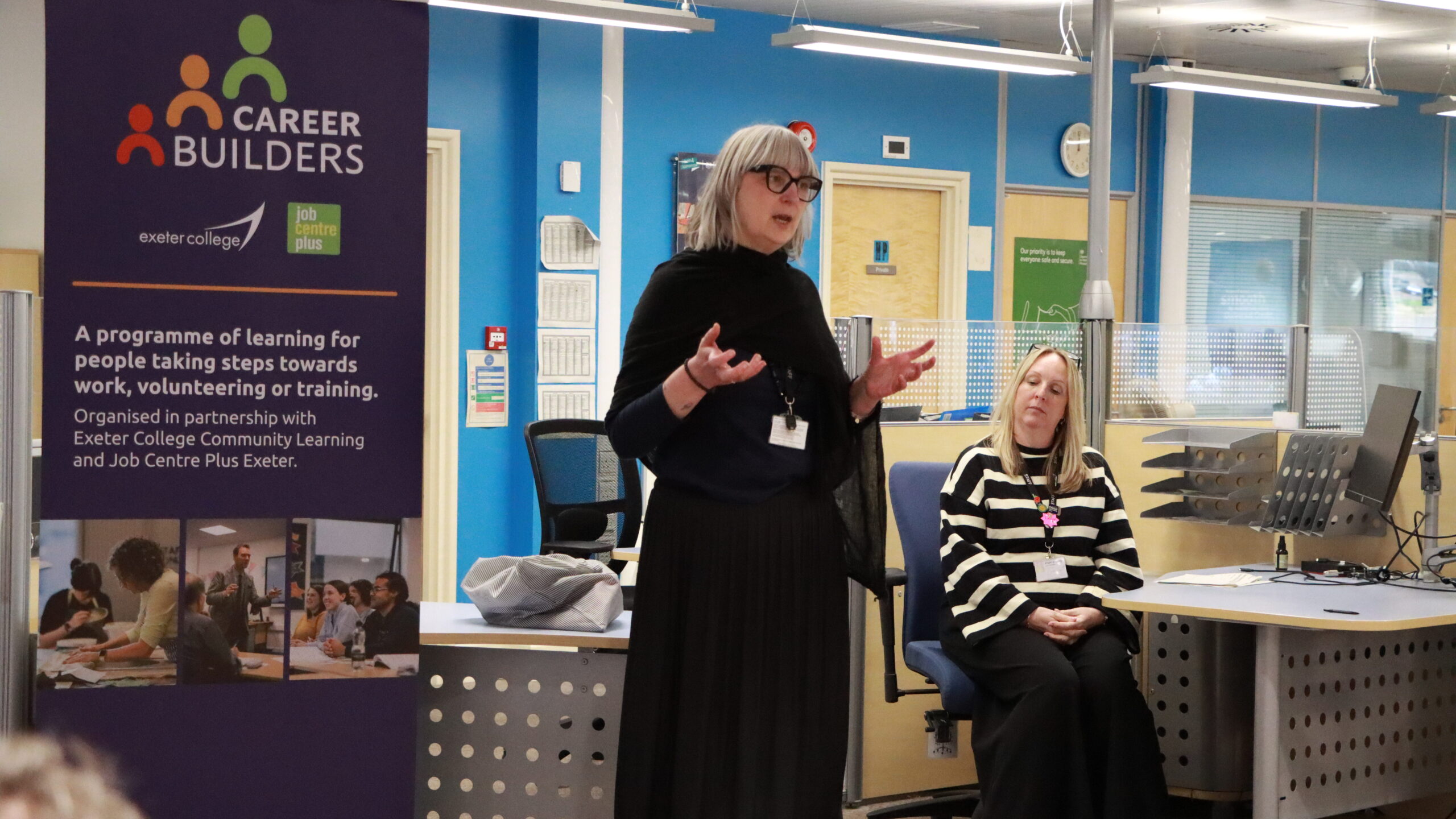 Woman presents to a group at Exeter College