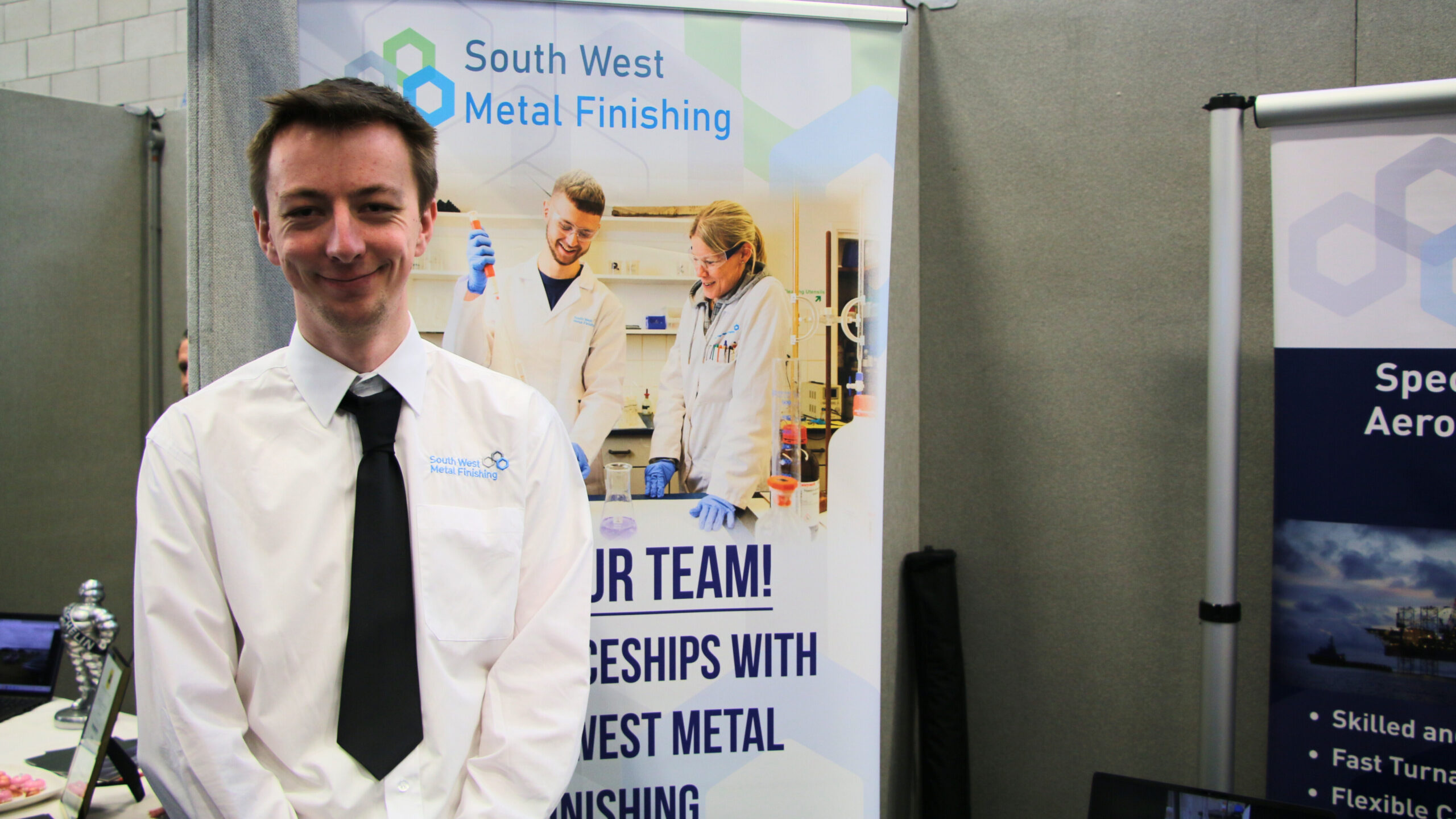 A man infront of a pull of a pull up banner