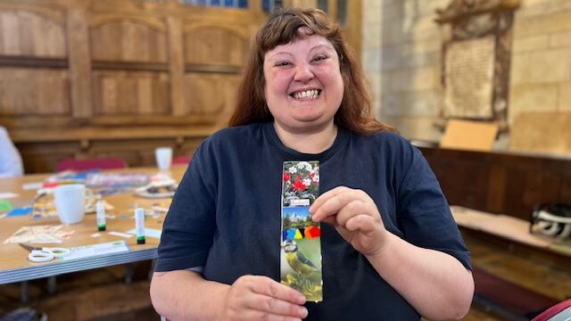 Woman holds up a bookmark