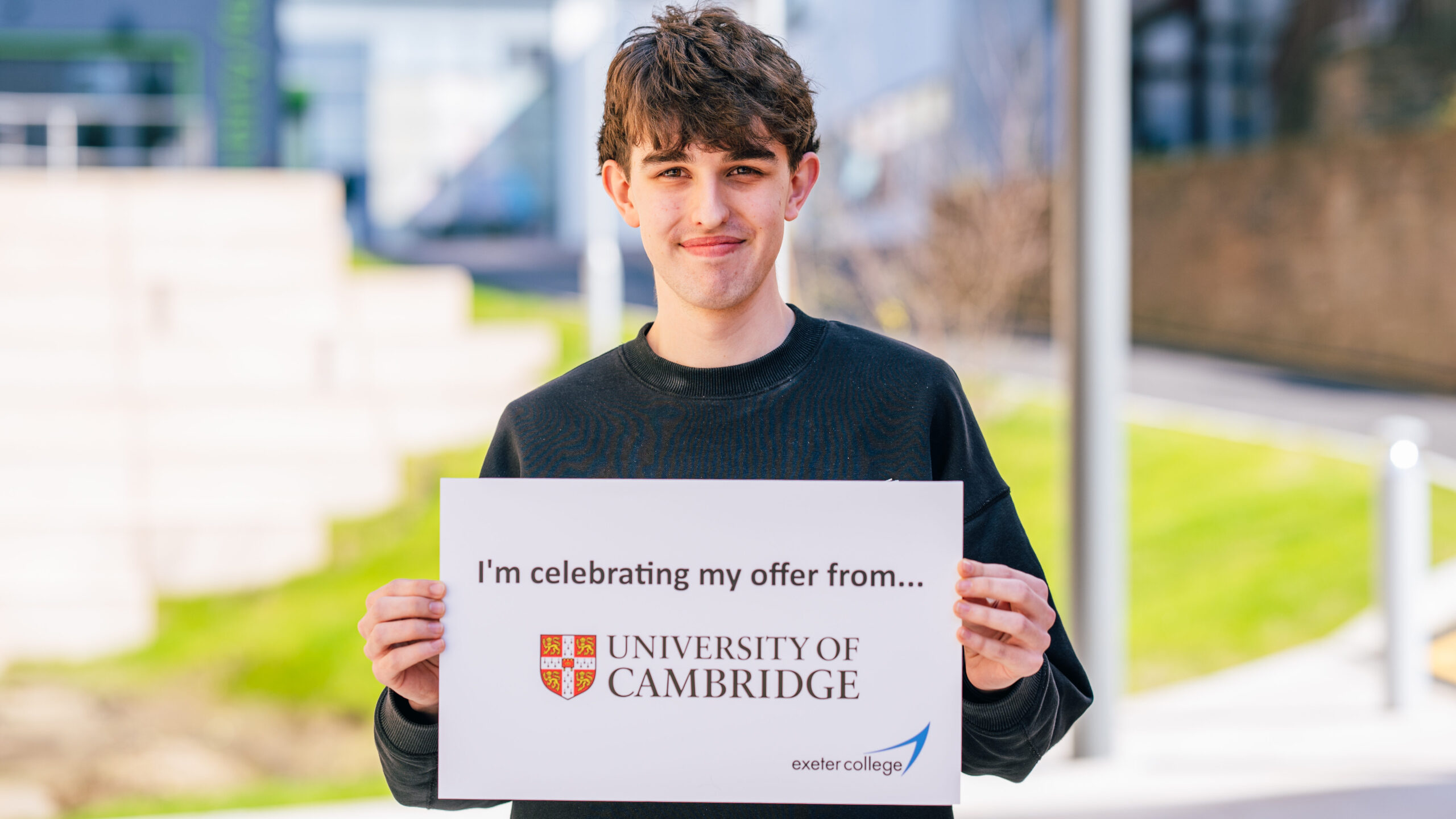 Exeter College student holds up a sign