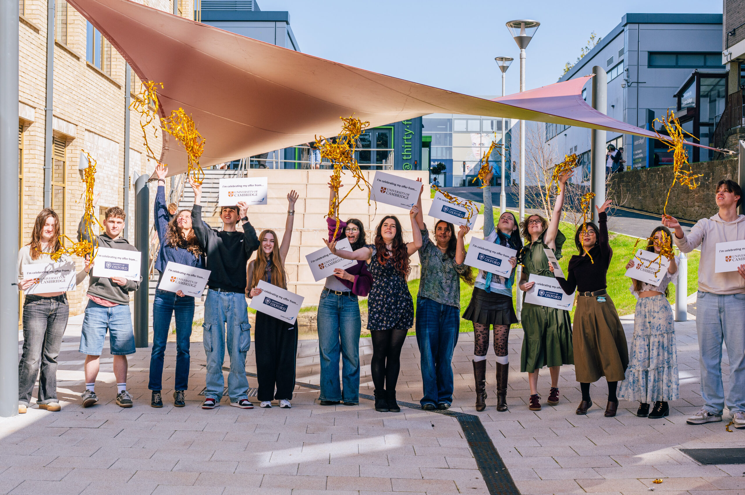 Exeter College students holding up signs