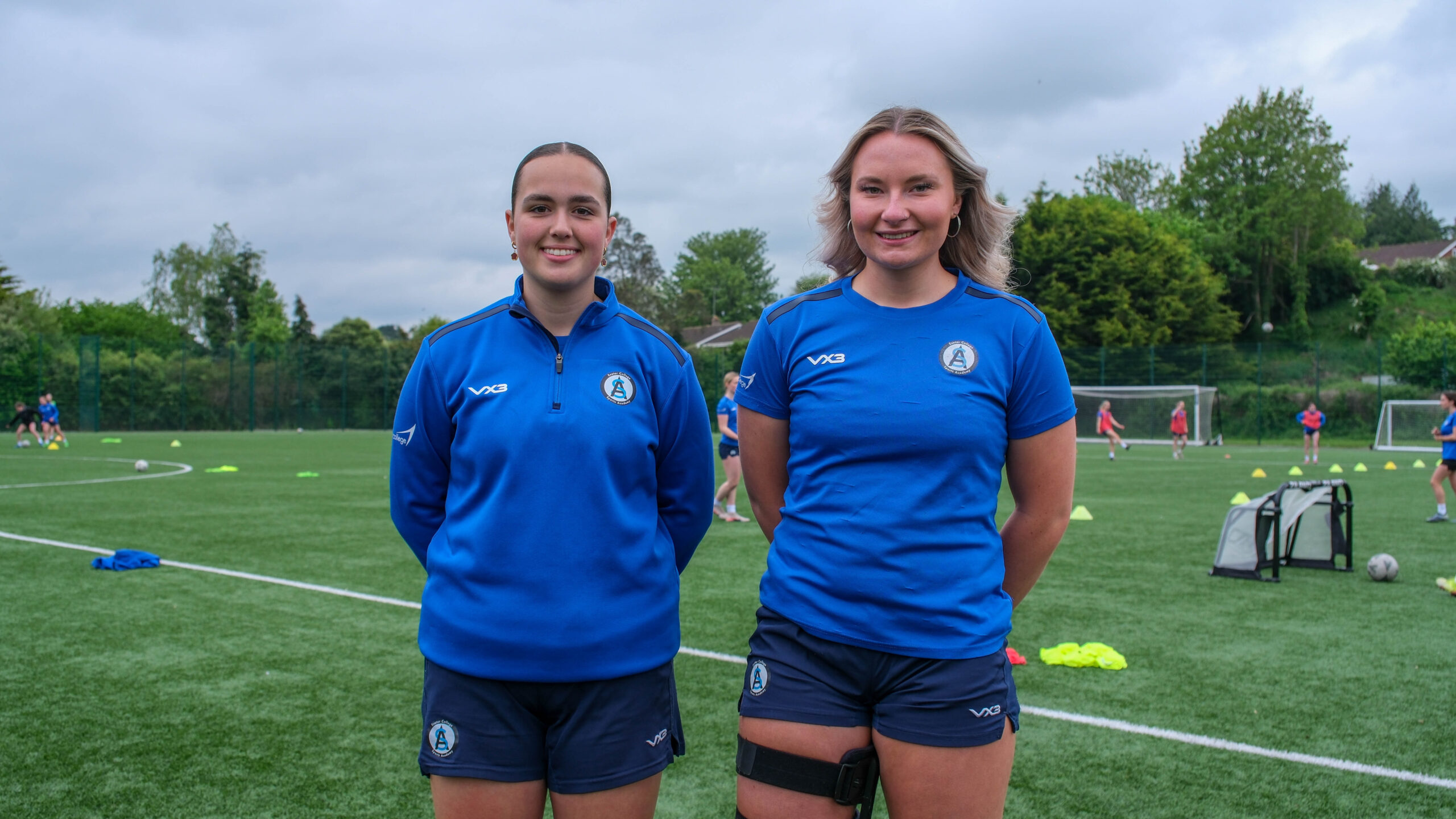 Two Exeter College football players on a pitch