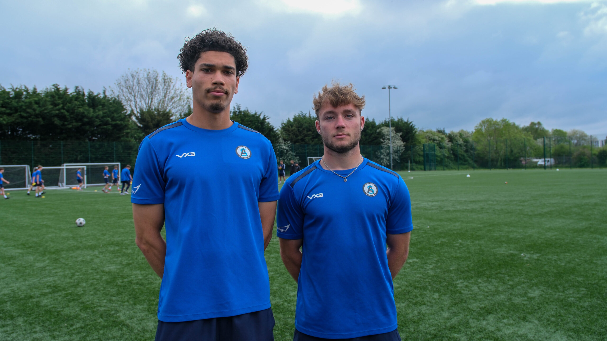 Two Exeter College football players on a football pitch