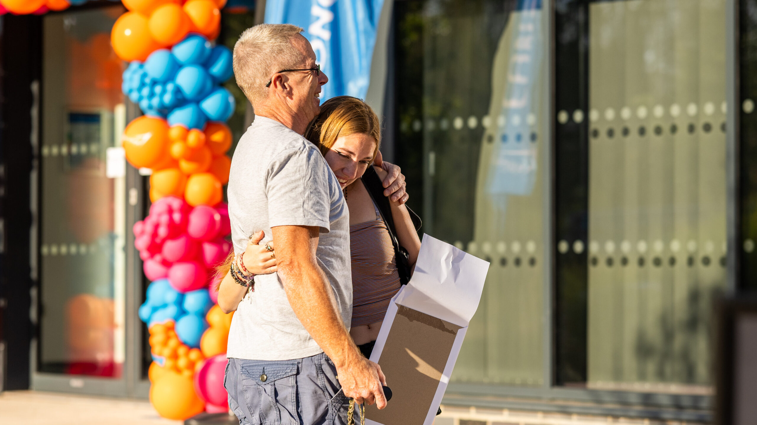 Exeter College learner hugs family member after receiving results